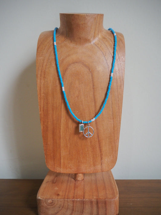 Blue and white seed bead necklace with green onyx baguette pendant and peace pendant