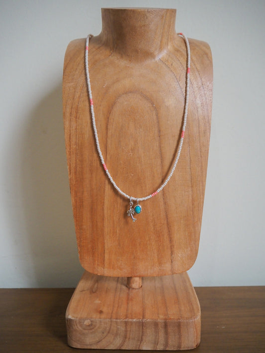 Ecru and pink seed bead necklace with turquoise pendant and palm tree pendant